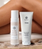 Women’s legs with the Sunkissed + Sculpted Set in front, which includes Neora’s best-selling Firm Body Contour Cream and 3-in-1 Self Tanning + Sculpting Foam.