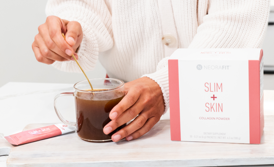 Lifestyle shot of a woman mixing NeoraFit™️ Slim & Skin in a cup.