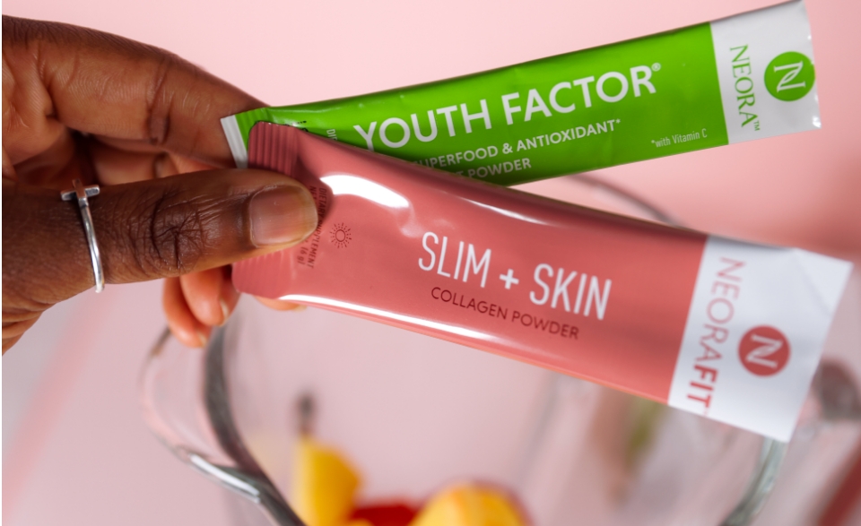 NeoraFit Slim + Glow Collagen Powder and Youth Factor Superfood & Antioxidant Boost Powder next to a blender